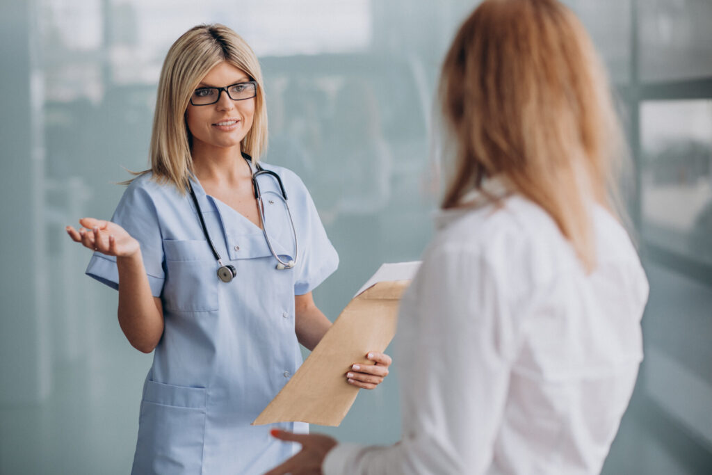 Young female doctor with patient at clinic
